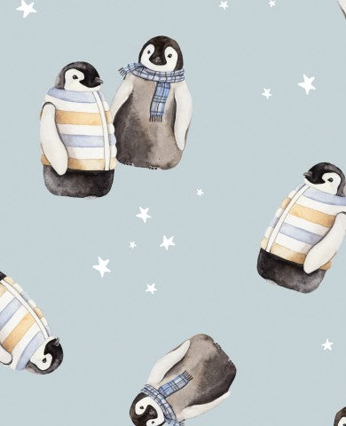 Muslin penguins in sweaters on a blue background
